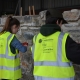 Women building a stone wall.