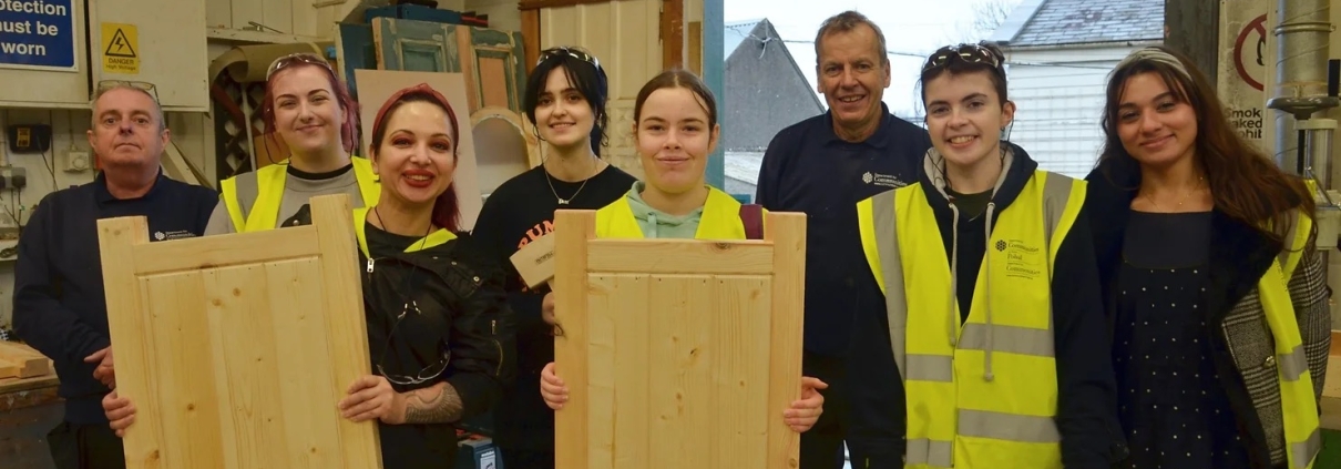 (Participants and their finished pieces alongside the joinery team at the Department for Communities’ (DfC) Historic Environment Division.)