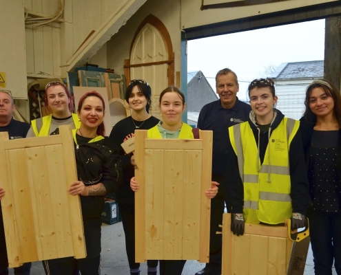 (Participants and their finished pieces alongside the joinery team at the Department for Communities’ (DfC) Historic Environment Division.)